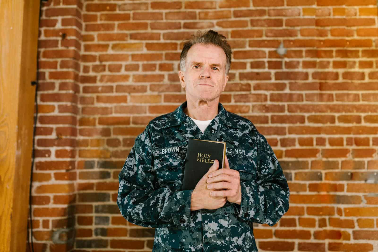 Photo of US Navy Soldier Carrying a Holy Bible